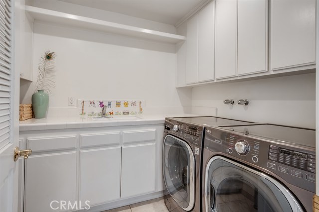 The laundry room is also on the upper floor, on the south side of the home and includes a large folding area and utility sink.