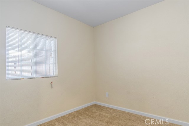 Bedroom 1 of 2 has carpet flooring and large window