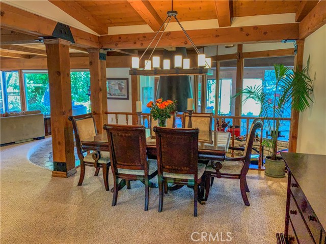 The open flow continues to the formal dining area and custom chandelier.