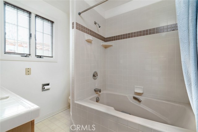 Master bathroom has large soaker tub/shower with tiled walls and tiled vanity. Sunny and bright west facing exposure