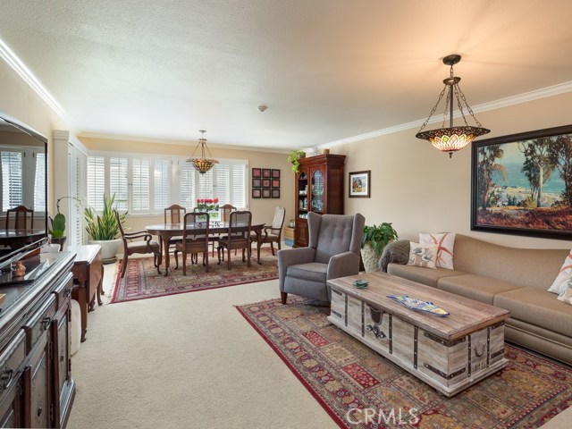 Welcome Home! Spacious open space greets you once you enter through the front door. Flexible great room allows for both living and dining spaces.  Note the gorgeous Tiffany chandeliers gracing both spaces.