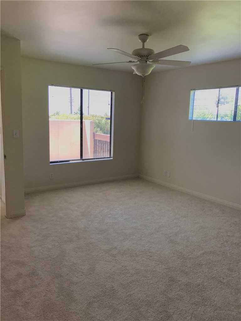 Bedroom #4 with new carpet, looks out onto deck