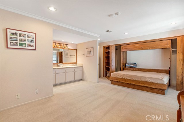 Murphy bed and bookshelves open as you can see. Area behind shelving is 2 separate closets! Murphy bed closes and looks like a very nice built in wall unit. this bedroom opens to its' own deck and also has its' own full bath.