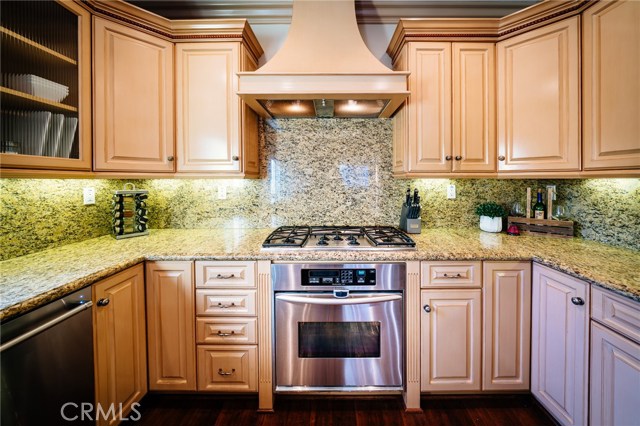 The attention to detail in the kitchen can be found in the style of the cabinetry, the layout of the stainless steel appliances, and the amount of counter space.