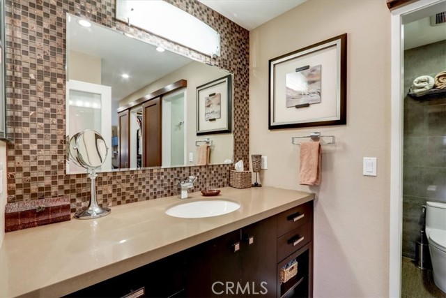 Primary Suite bathroom with Cesar Stone counters, custom cabinets and glass back splash.