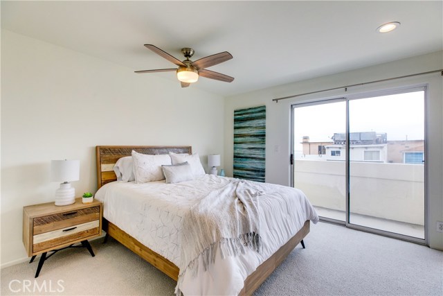 On the main entry level are 2 bedrooms. This is south bedroom with access to the balcony, new carpeted floors and large closet.