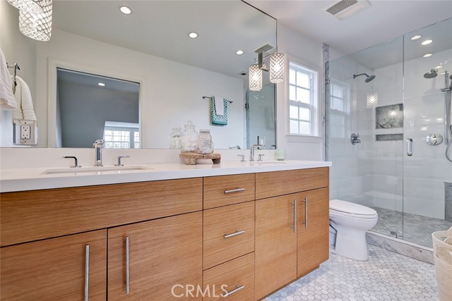 Master bath with double sinks and custom fixtures.