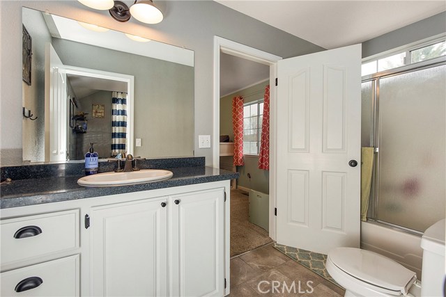 Jack and jill bathroom with tub/shower combo, granite slab counters & updated fixtures