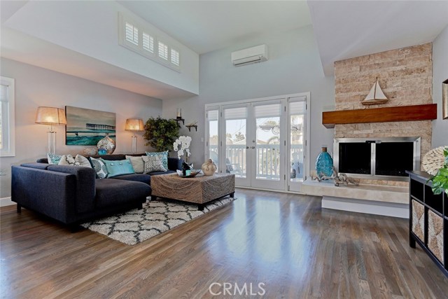 Living area with adjacent balcony and new Mitsubishi A/C unit.