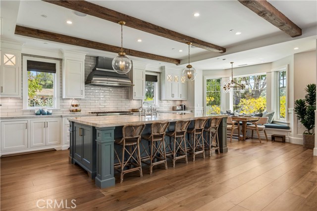 Gourmet kitchen complete with Thermador appliances, twin mini fridges, double sinks & dishwashers, column freezer/fridge, walk-in pantry and bay-window-framed dining nook