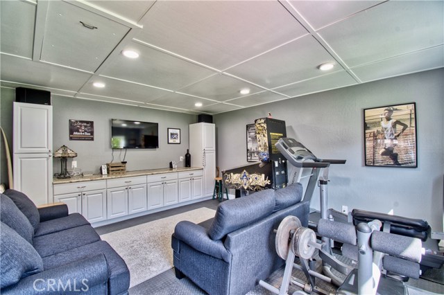 bonus room has built-in cabinetry, stone bar & recessed lighting