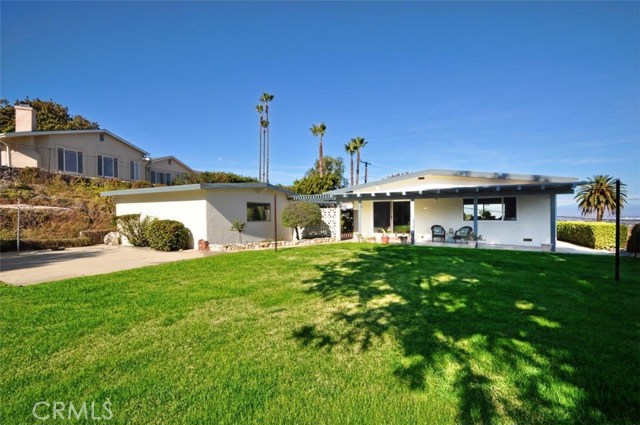 Large grassy yard looking back toward the house and garage.