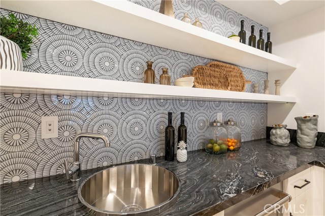 Spectacular Wet Bar with zebra marble, Asko dishwasher, microwave and fridge