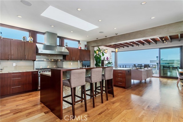Gourmet kitchen with Viking range hood Mahogany cabinets and stunning walnut floors with a view