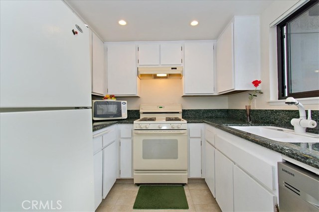 Kitchen with granite counters and refrigerator Kitchen with granite counters and refrigerator
