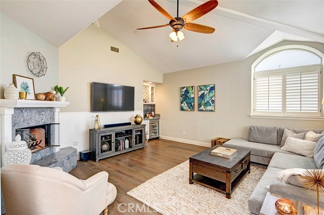 Upstairs family room with vaulted ceilings, fireplace & bar area