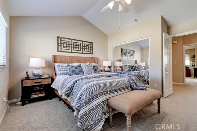 Peaceful master bedroom retreat with dual door entry doors and mirrored wardrobe closet.