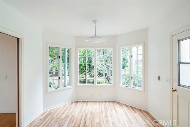 Sunny, private breakfast nook looks out at brick patio and fruit tree paradise! Laminate floor is in nook area only.