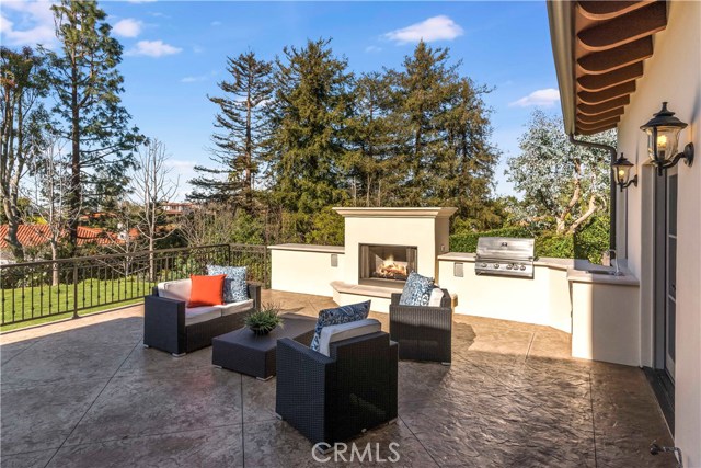 Terrace with fireplace and outdoor kitchen