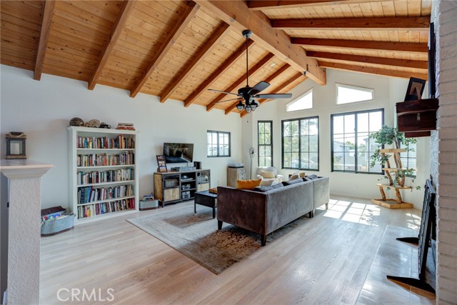 Upstairs living area with high open beam ceiling and hardwood floors