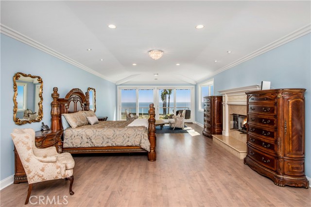 Master bedroom with panoramic ocean views and fireplace