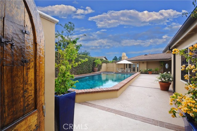 Hard-carved front gates to the lovely and private front patio and pool