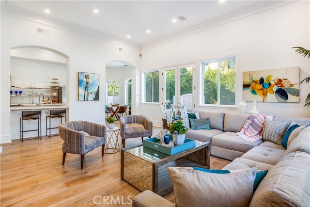 The open floor plan flows seamlessly from the living room to the breakfast bar and into the kitchen