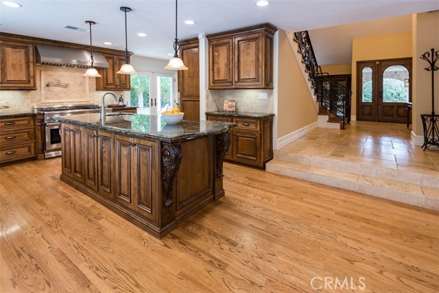 Custom cabinetry, hardwood flooring, Thermador appliances, Labrodite granite.