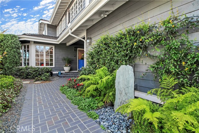 Front Entry with new Lush Landscaping with custom brick entry and waterfall.