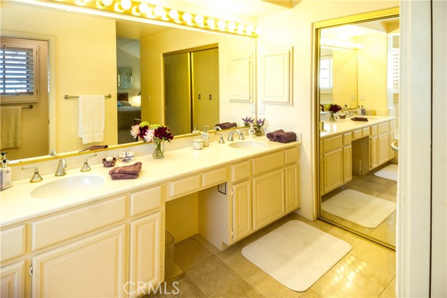 Master bathroom includes large mirrored slider closet doors.