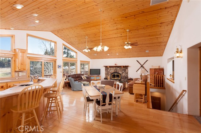 This is what you see when you open your front door, an amazing open floor plan with wood vaulted ceilings, wood flooring and rock fireplace. Large picture windows give you a panoramic view of the lake and mountains.