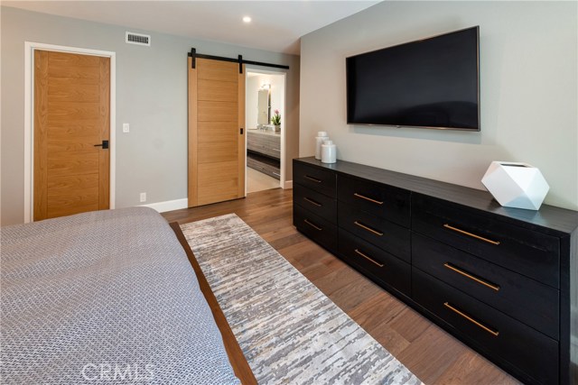 Custom finishes like this barn door to the master bath