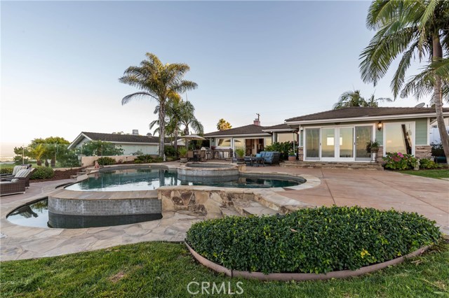 Another back yard angle.  Notice the clear glass fences to capture even more views! Infinity pool and spa are gorgeous!