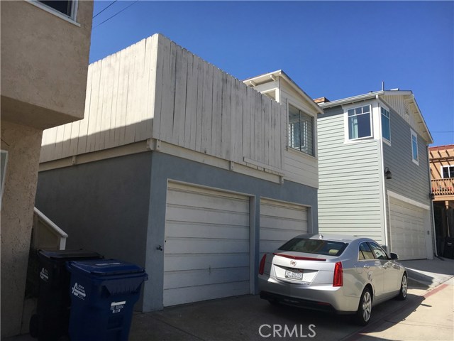 View of the alley entrance to the garage.  There is room to park a car in front of the garage.
