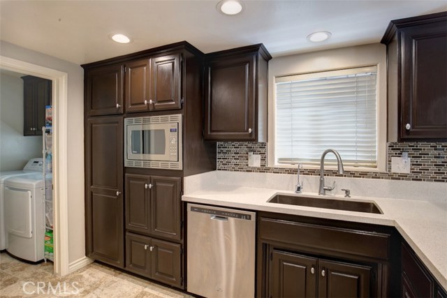 Kitchen, recessed can lighting, quartz counters, natural wood cabinets and brushed stainless appliances