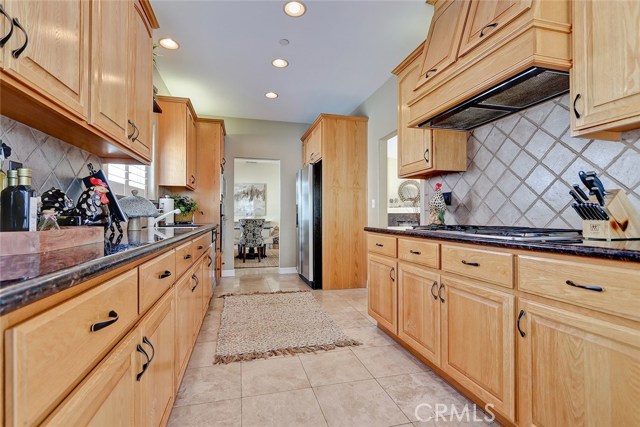 6-burner gas stove and beautiful tiled backsplash.