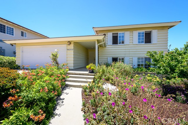 Flowers and fruit tree adorn the front entry.