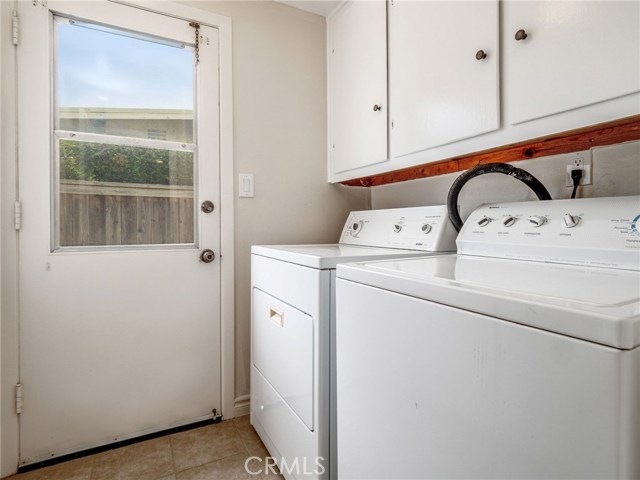 Separate Laundry Room with Cabinets; access to side yard that goes to the front or the back; gated