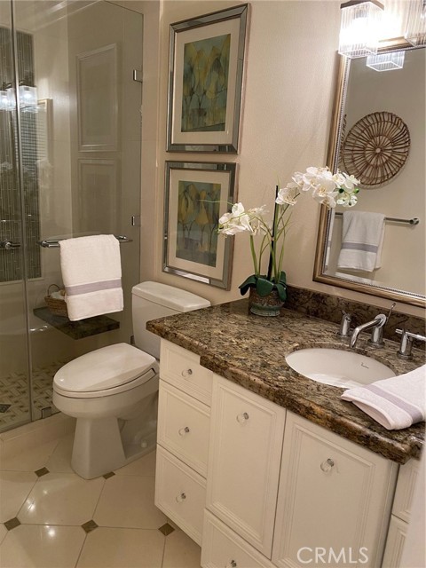 The second bath features an easy walk-in shower with gorgeous glass tile accents