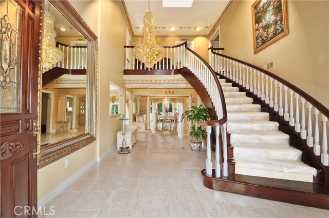 tile entry with Chandeliers, large mirror .