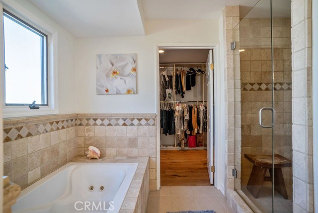 Master Suite Bathroom includes large enclosed shower, jetted tub, and customized spacious walk-in closet.