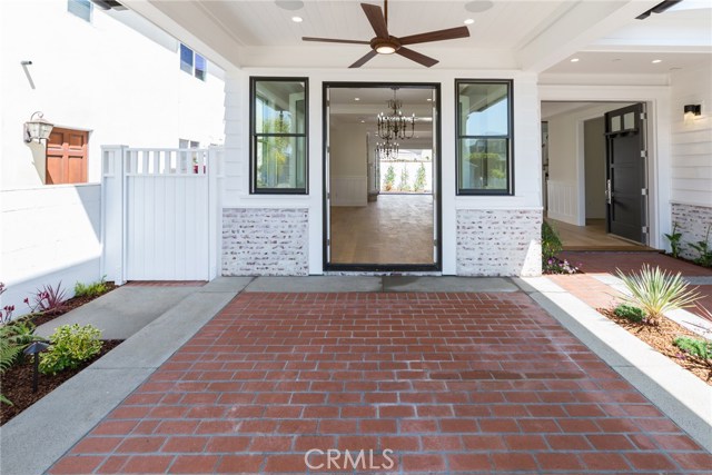 Covered front patio and whitewashed brick siding. Looking into the Living room.