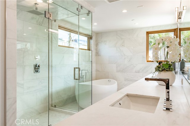 Master bath with shower, soaking tub covered with Calcutta Bella marble
