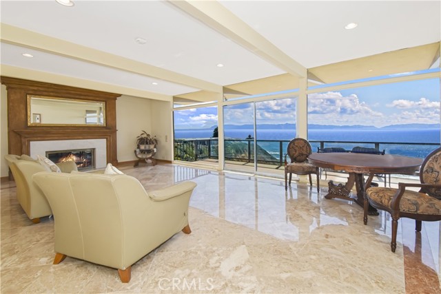 Living room with gorgeous floors, fireplace and walls of glass to the panoramic views!