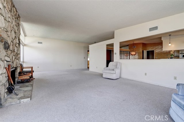 LIVING ROOM LOOKING WEST AND SHOWING THE RELATIONSHIP TO THE DINING/FAMILY ROOM.