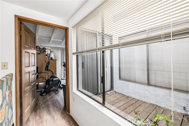 Upper hallway leading to the main bedroom. Atrium brings in natural light.