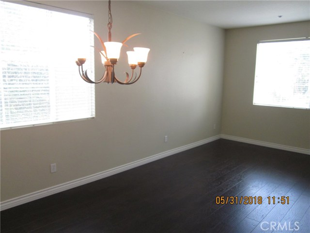 View of living room from dining room.  Lots of big windows and light.