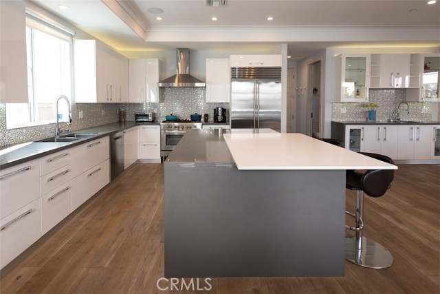 Laquer cabinets, oversized island with fridge, stainless steel appliances...truly making cooking a wonderful experience