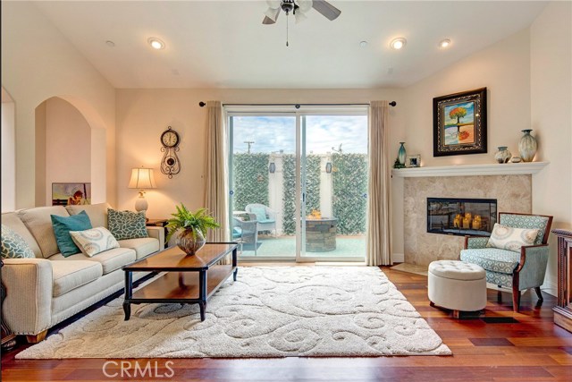 Bright open living room with beautiful cherry wood floors, recessed lights, gas fireplace, ceiling fan.  Attached large and private balcony off the living room.