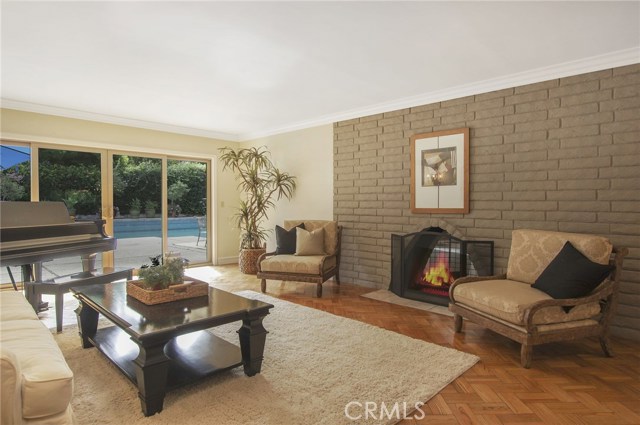 Living room has space for a piano, view to spacious entertaining back yard